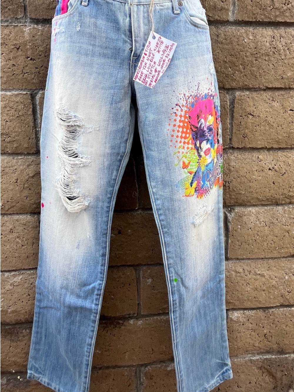 Light Wash Distressed Women’s Jeans with Vibrant Paint Graphic